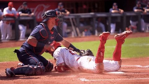 Catcher tagging out a runner at home plate in slow motion