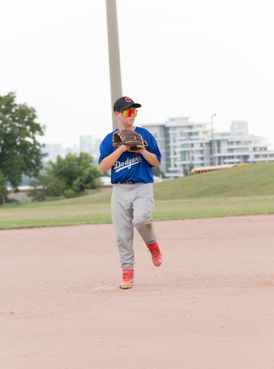 Young pitcher starting the leg kick, real game